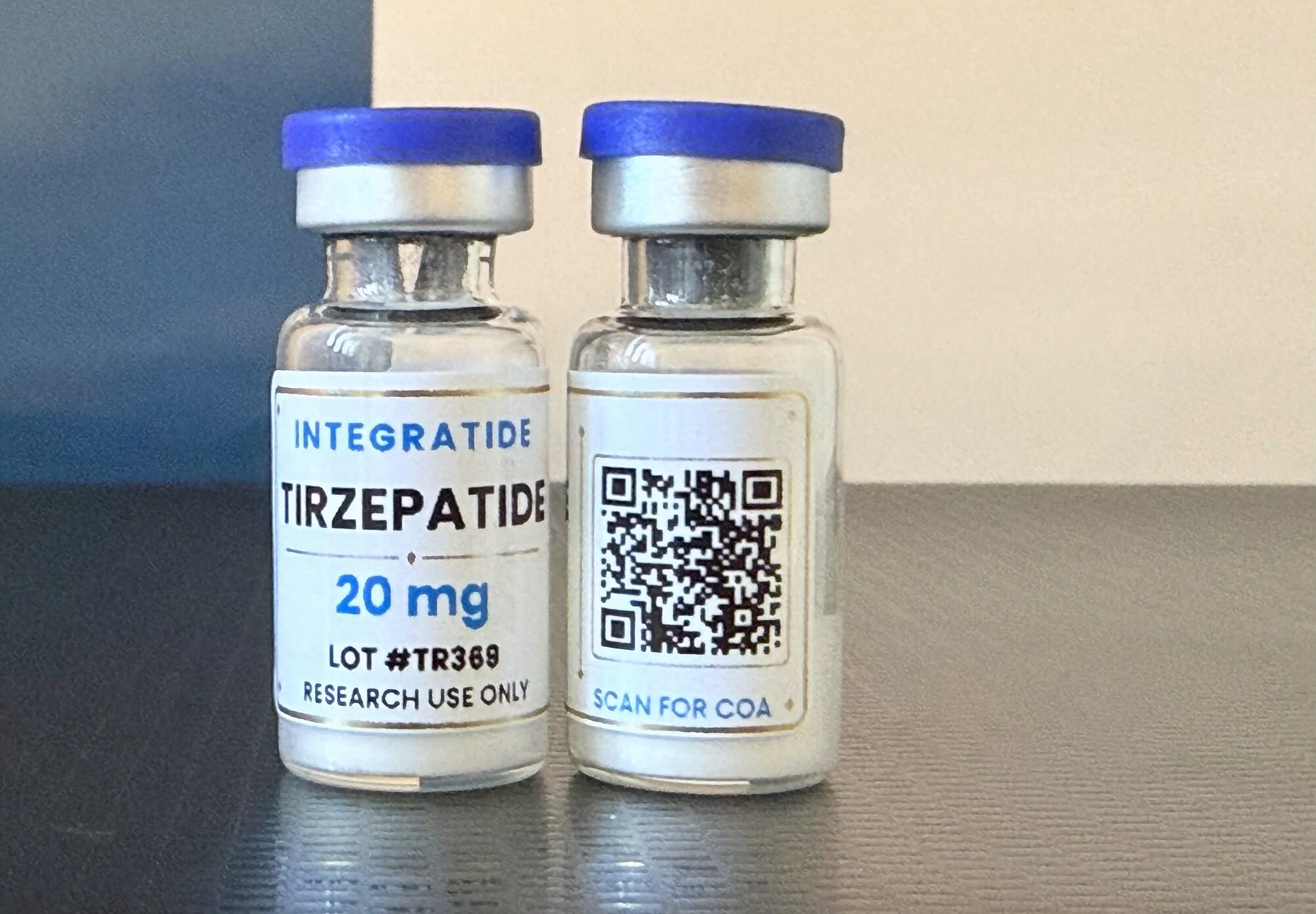 Two Integratide Tirzepatide 20 mg vials, the back label showing the scan-for-COA QR code for lot TR369